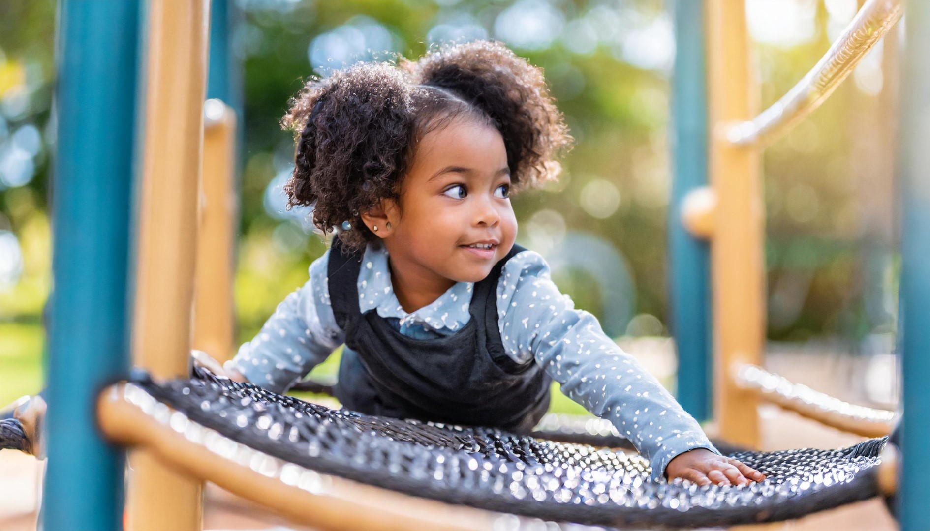 Toddler Climbing in Playground - Chaos Created AF A happy child, smiling.